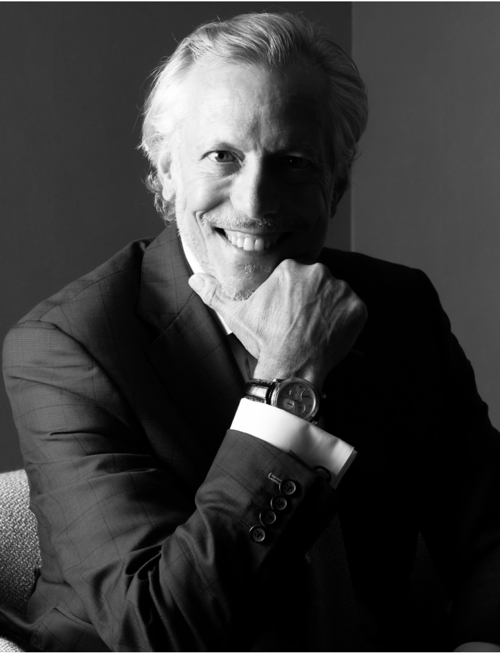 Dr. Pearlman smiling in suit in black and white