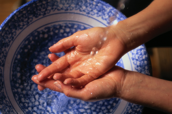 washing hands over patterned blue sink