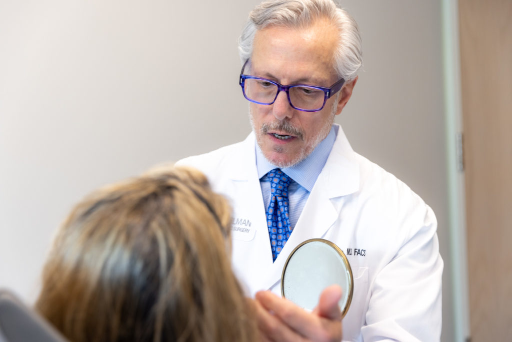 Dr. Steven Pearlman conducting a permanent lip augmentation consultation at his NYC practice