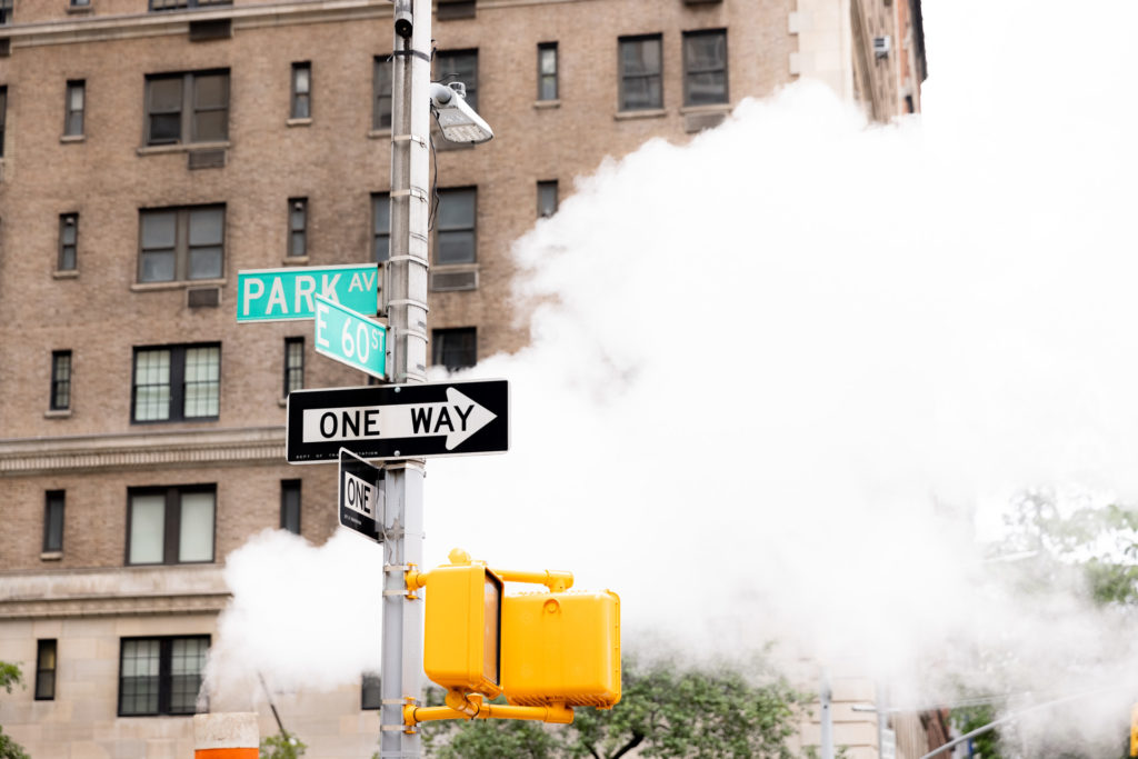New York street signs and smoke