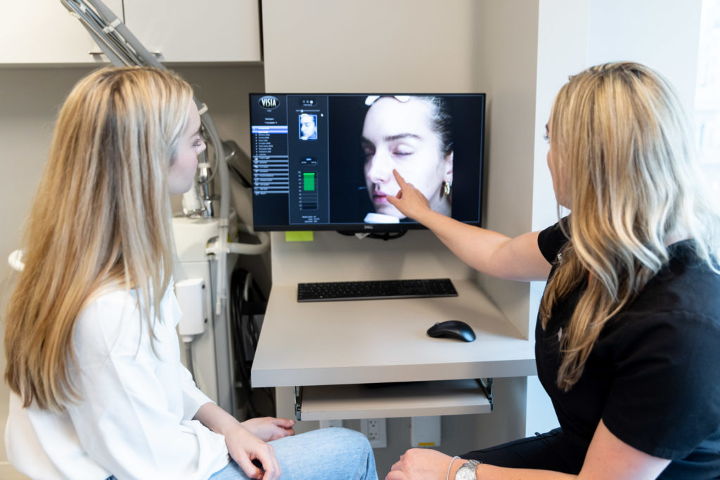 Visia with specialist showing the patient about images on a screen