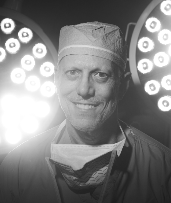 Dr. Pearlman ready for surgery with lights in black and white