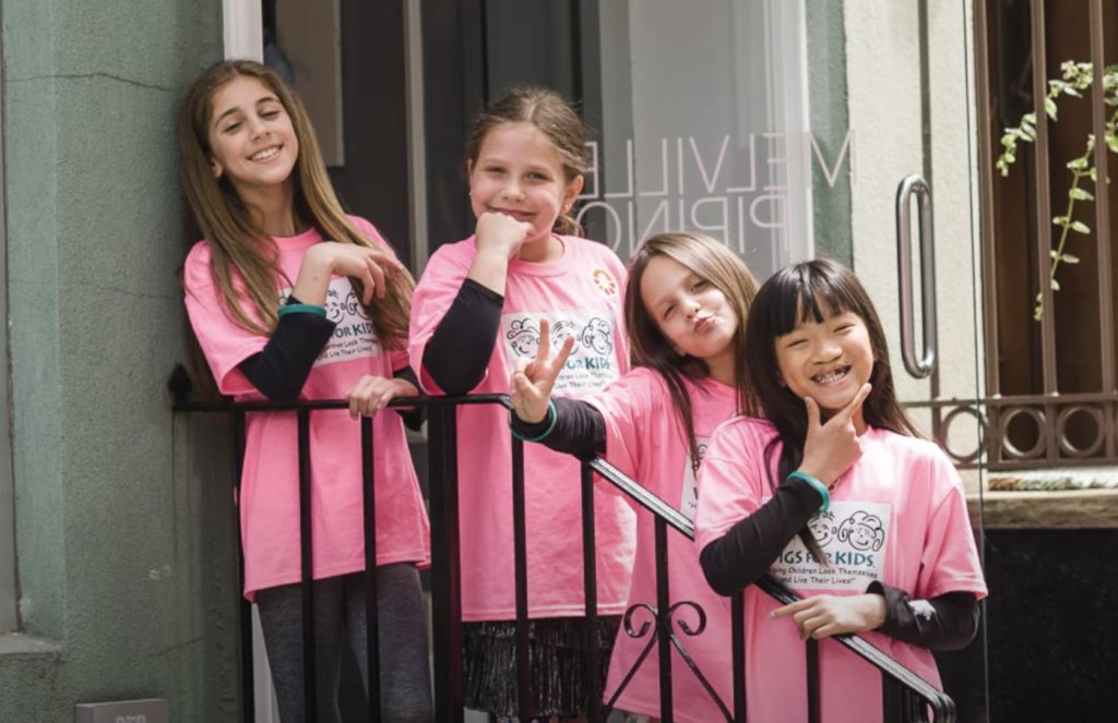 Young girls wearing matching pink shirts