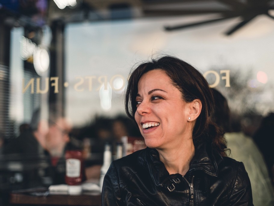 happy woman in leather jacket at restaurant