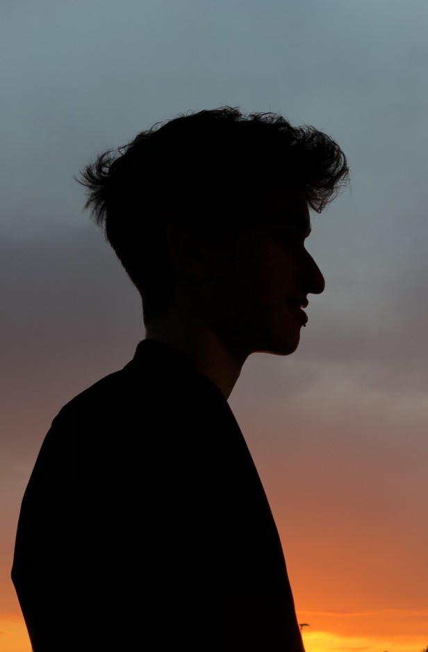 side silhouette of a man at sunset