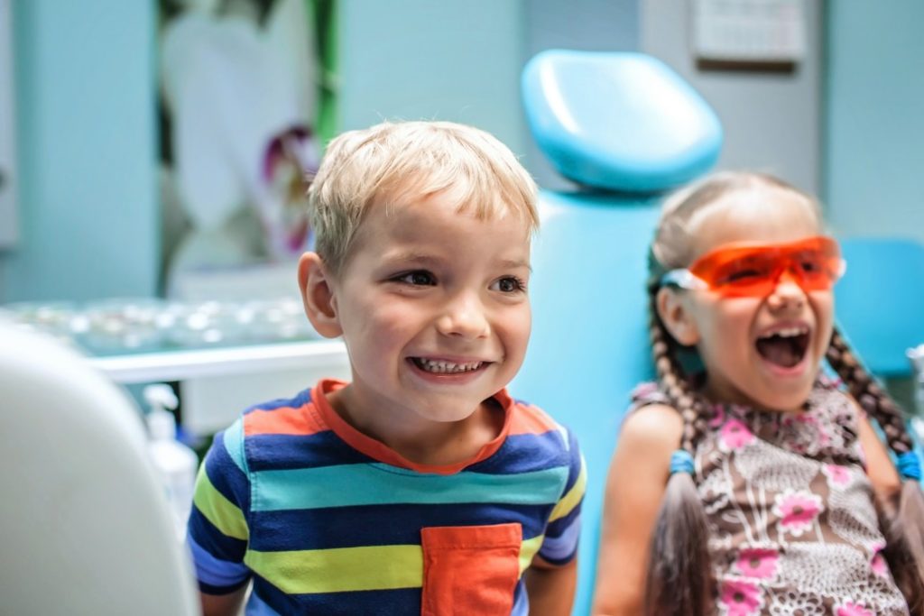 young children laughing in a doctor's office